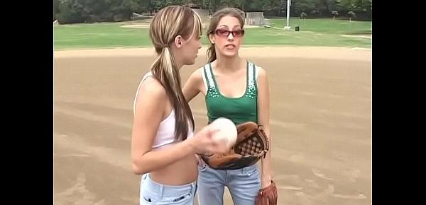  Coach shows two female athletes how to properly handle a big bat